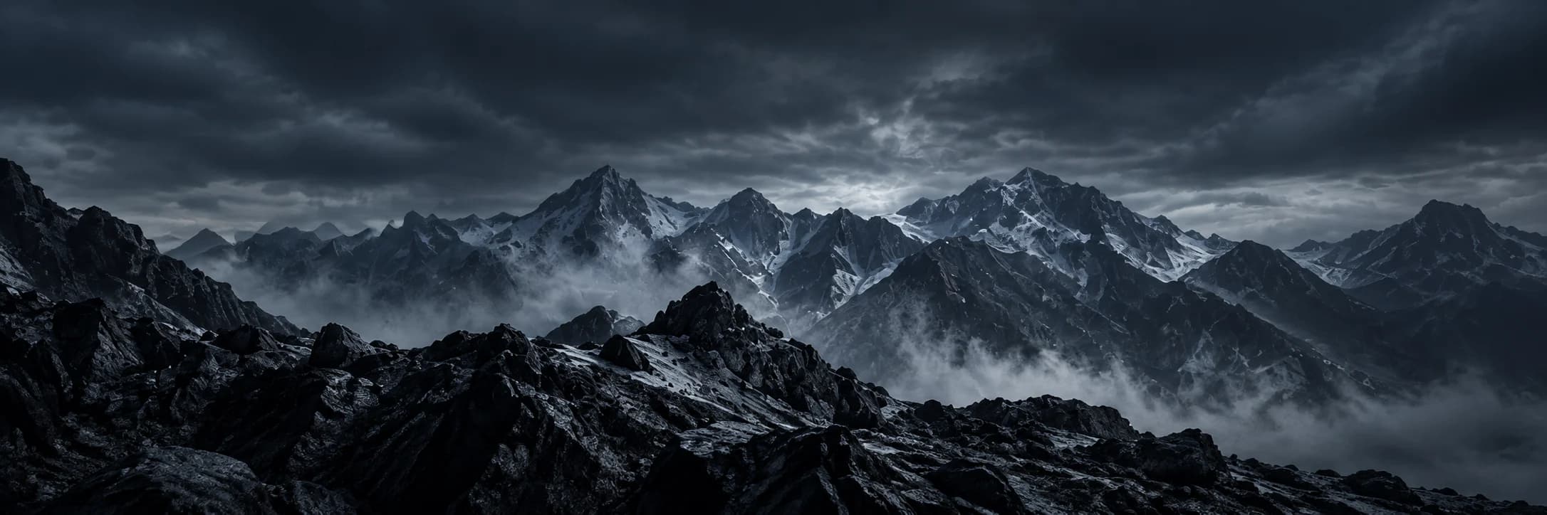 A vast range of dark, snow-capped mountain peaks