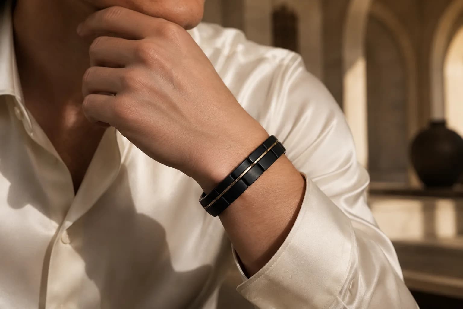 Black titanium bracelet worn with an ivory shirt